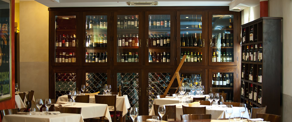 classic dining room and wine selection at Osteria dell'Arco